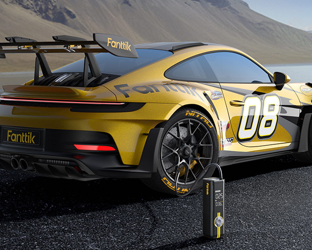 Żółto-czarny sportowy samochód na tle gór, Fanttik X8 Pro pompuje jego oponę