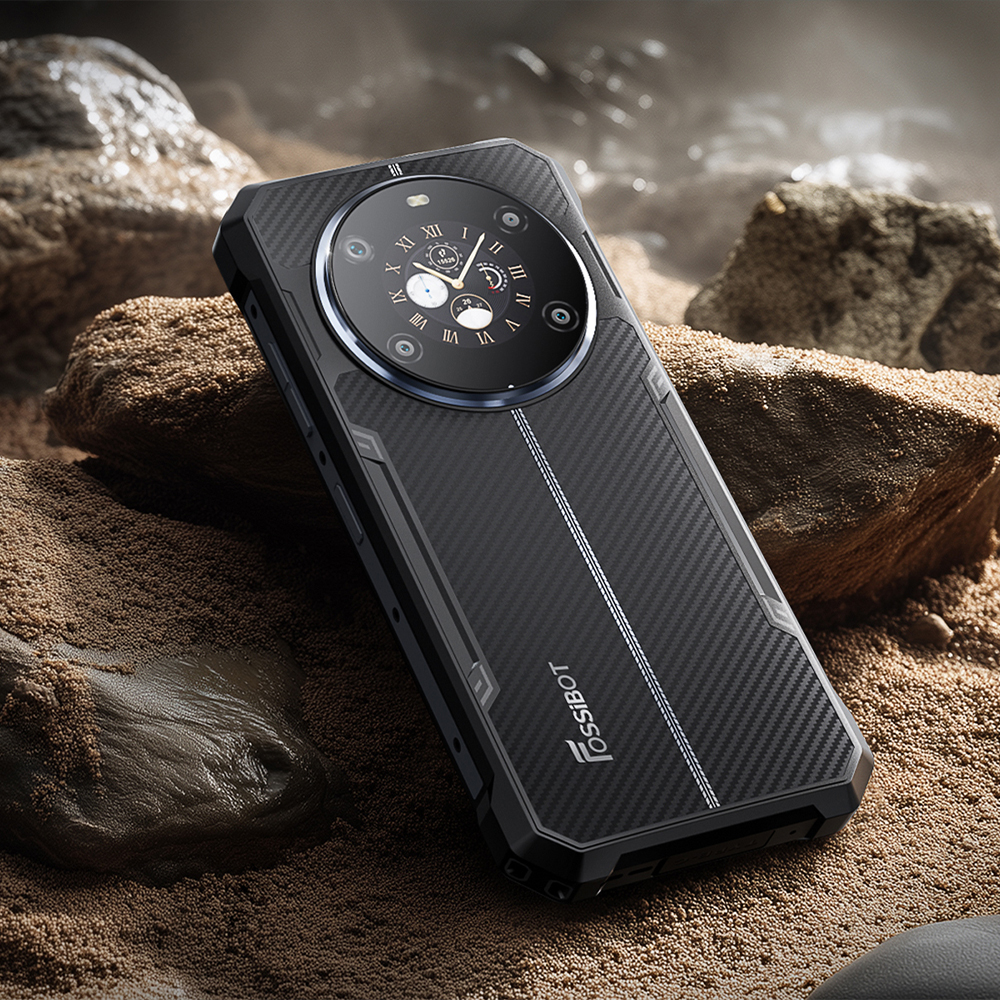 Telefon Fossibot F109S  leżący na piasku i kamieniach.